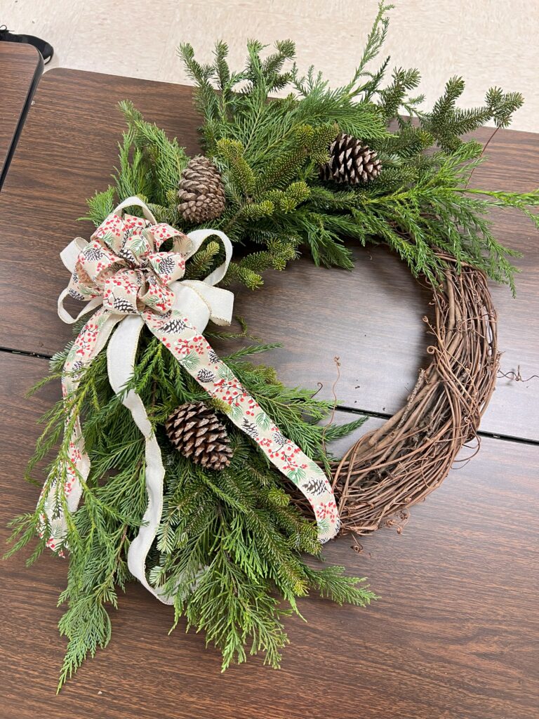 A wreath with a long bow.