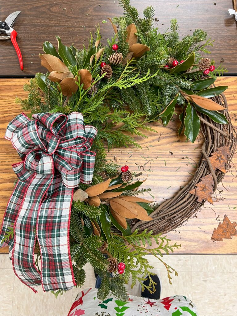 A wreath with a green and white bow.